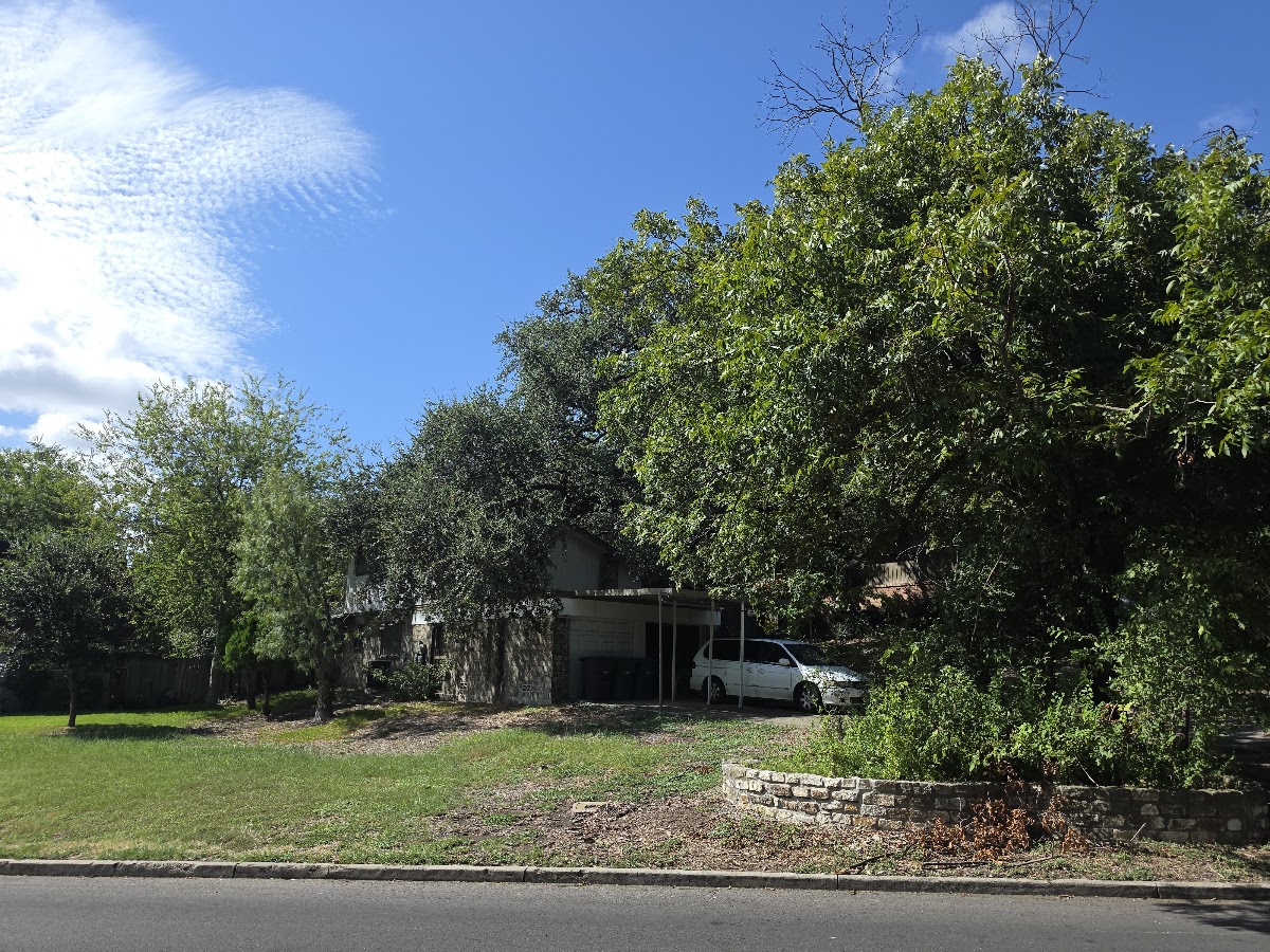Lush green lawn and stone retaining planter at 5602 Charlie Chan Dr, San Antonio